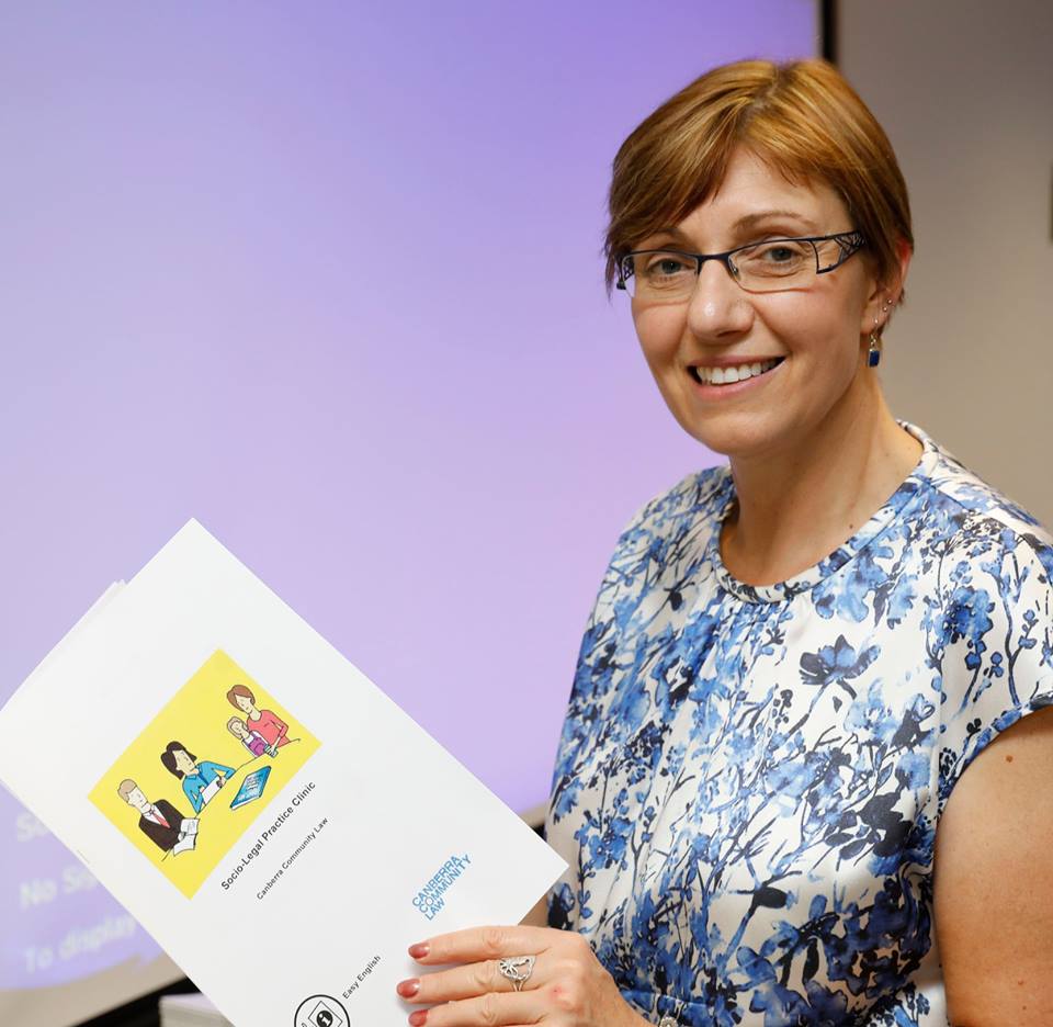 Rachel Stephen-Smith holds an Easy English brochure about Canberra Community Law services