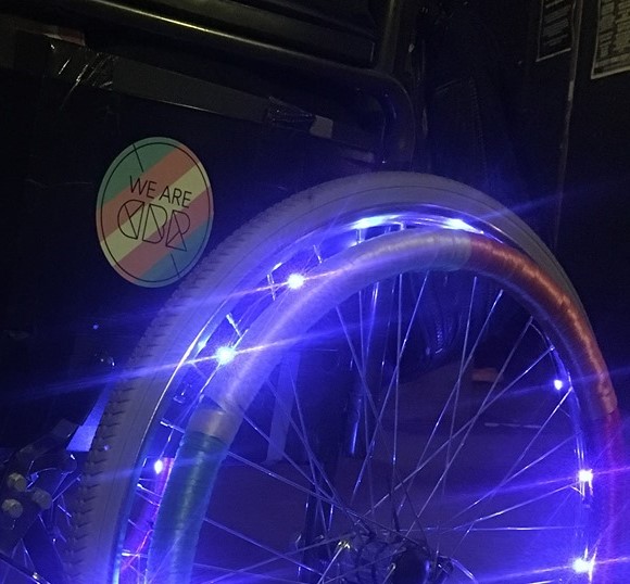 Wheelchair with lights and rainbow and a We Are CBR sticker